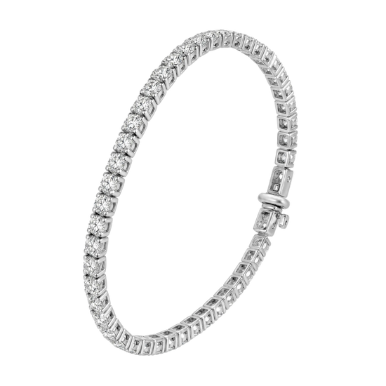 A silver tennis bracelet featuring a continuous row of round-cut clear gemstones in a prong setting, with a polished clasp closure, shown on a plain white background.