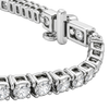 A close-up of a silver tennis bracelet with round-cut clear stones in a box setting and a polished clasp, photographed on a white background.