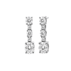 A pair of silver-toned drop earrings with a vertical channel setting of round and oval-cut clear stones, including a larger oval stone at the bottom, shown on a plain white background.