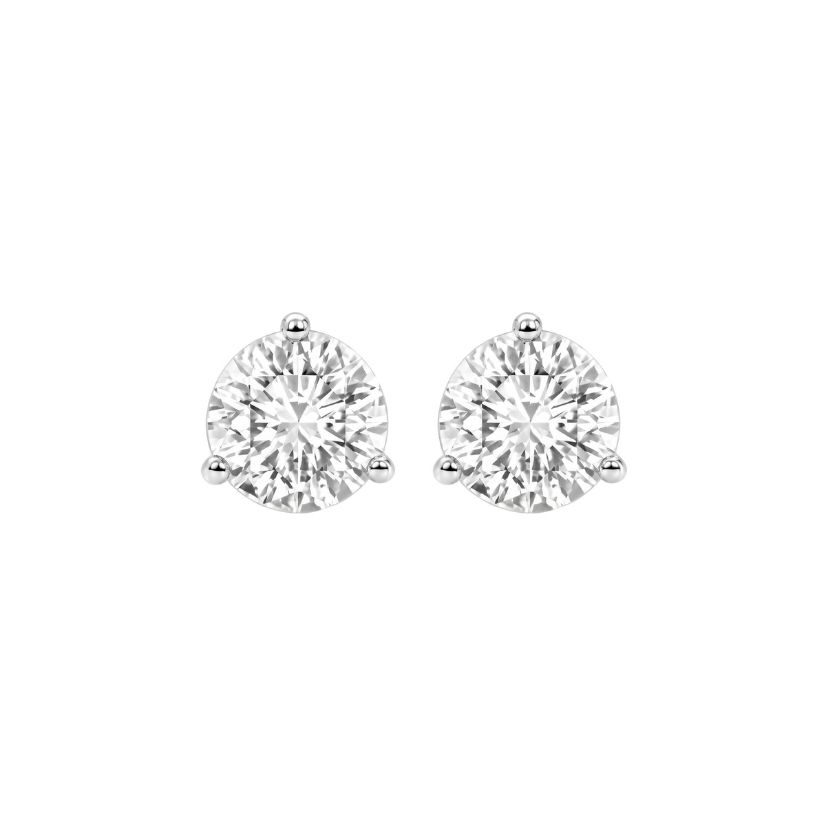 Close-up front view of two round-cut diamond stud earrings in three-prong settings.