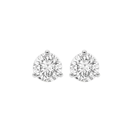 Close-up front view of two round-cut diamond stud earrings in three-prong settings.