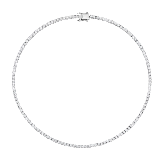A silver tennis necklace with a row of small clear stones, featuring a rectangular clasp, shown on a plain white background.