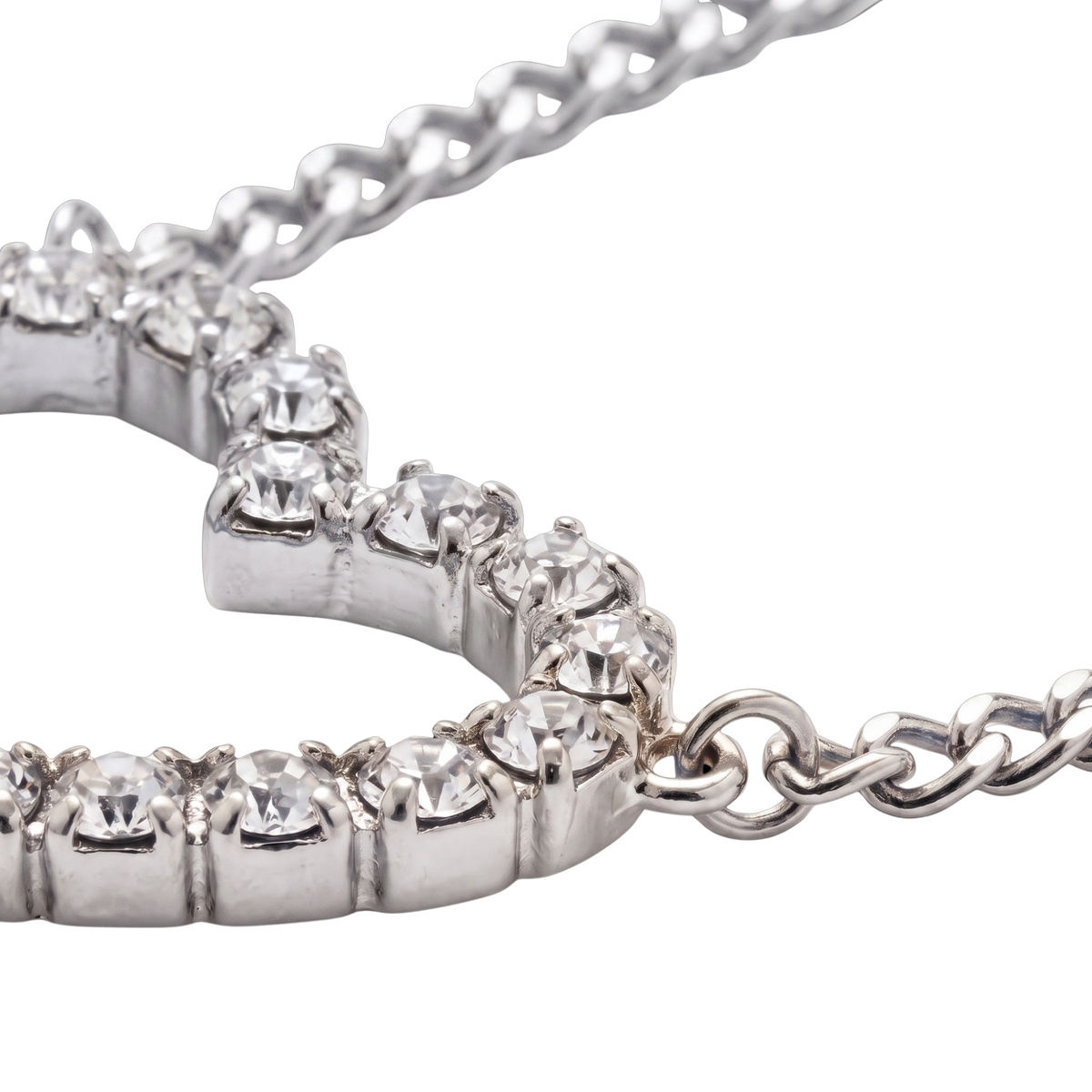 Close-up of a silver-toned tennis bracelet with clear round-cut stones, shown on a plain white background.