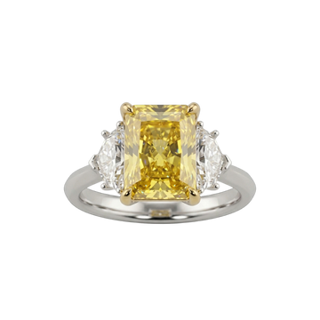 A top-down view of a three-stone engagement ring against a solid black background. The center features a large, pastel yellow emerald-cut diamond set in four yellow gold prongs. It is flanked by two smaller, clear white diamond side stones. The band of the ring is a smooth, polished white metal.