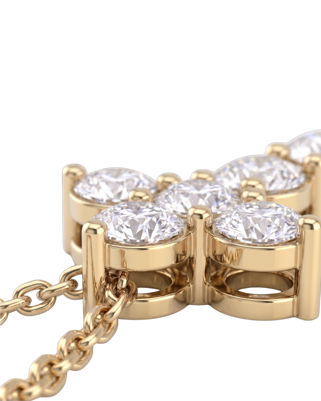 Extreme close-up of the base of a yellow gold diamond cross pendant, showcasing the intricate metal basket setting beneath the sparkling stones and the attached chain.